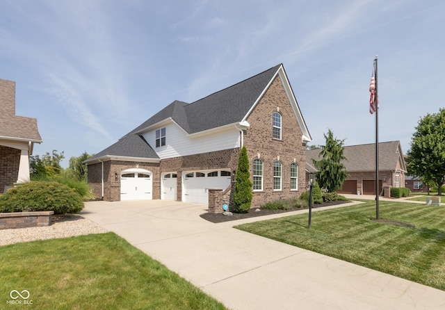 10334 Strongbow Rd, Fishers, IN 46040 - view of front of house with brick siding, concrete driveway, a front yard, and a garage