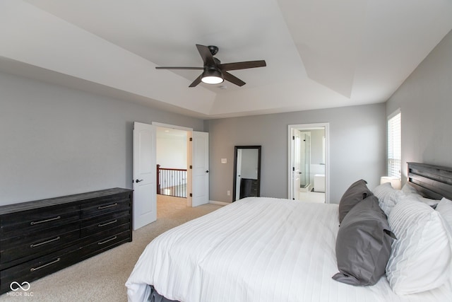 10334 Strongbow Rd, Fishers, IN 46040 - bedroom with light carpet, a raised ceiling, connected bathroom, and ceiling fan