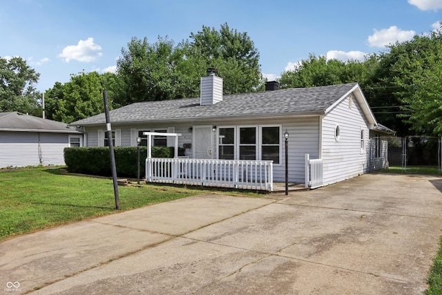 4113 Red Bird Dr, Indianapolis, IN 46222 - ranch-style house with a front yard, a chimney, driveway, and a shingled roof