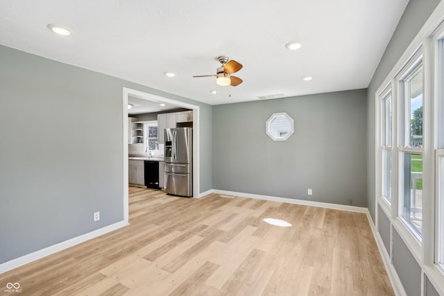 4113 Red Bird Dr, Indianapolis, IN 46222 - unfurnished living room featuring a ceiling fan, light wood-style flooring, and recessed lighting