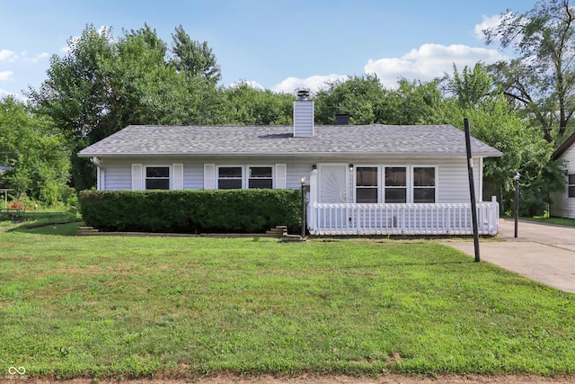 4113 Red Bird Dr, Indianapolis, IN 46222 - ranch-style home featuring a front yard, a chimney, and roof with shingles