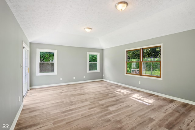 4113 Red Bird Dr, Indianapolis, IN 46222 - unfurnished room with a textured ceiling, light wood-type flooring, and lofted ceiling