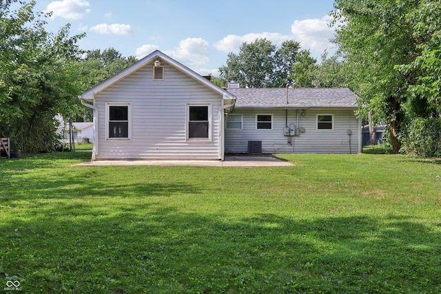 4113 Red Bird Dr, Indianapolis, IN 46222 - back of property featuring a patio, a yard, and a chimney
