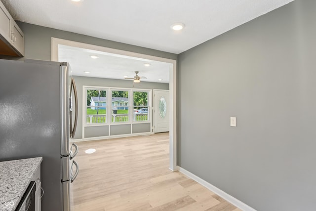 4113 Red Bird Dr, Indianapolis, IN 46222 - kitchen featuring stainless steel appliances, recessed lighting, a ceiling fan, light wood-style floors, and light stone counters