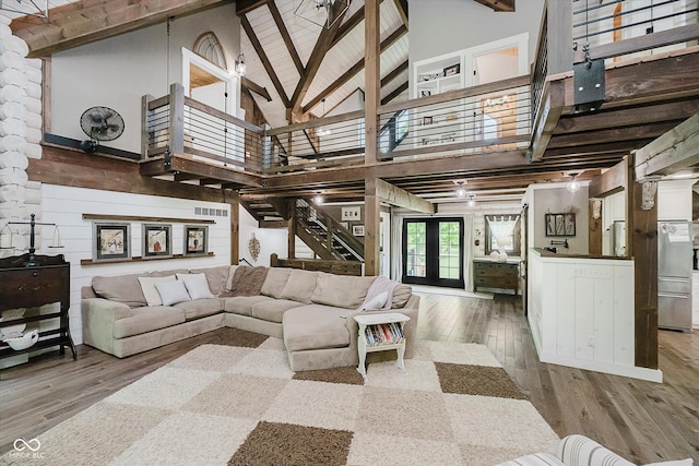 10823 E 200 N, Sheridan, IN 46069 - living room featuring hardwood / wood-style floors, high vaulted ceiling, beam ceiling, stairway, and decorative columns