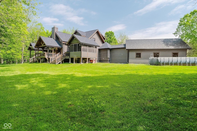 10823 E 200 N, Sheridan, IN 46069 - back of house with a sunroom, stairway, a lawn, and a swimming pool