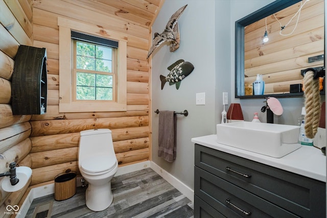 10823 E 200 N, Sheridan, IN 46069 - bathroom featuring log walls, vanity, and wood finished floors