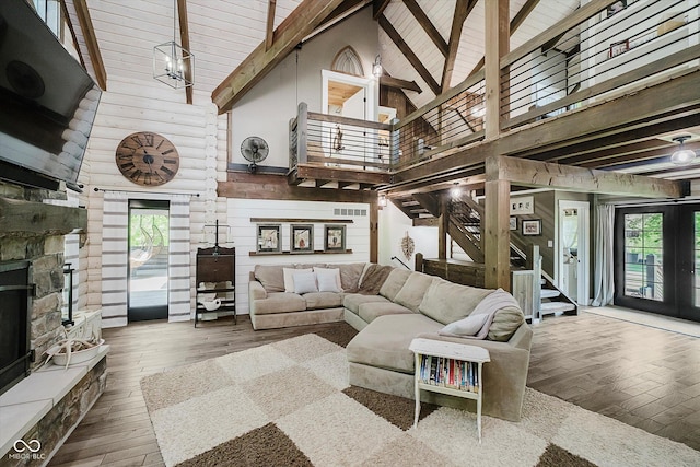 10823 E 200 N, Sheridan, IN 46069 - living area featuring high vaulted ceiling, stairs, hardwood / wood-style floors, plenty of natural light, and a stone fireplace