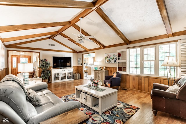 5123 Marble Ct, Indianapolis, IN 46237 - living room featuring wainscoting, light wood finished floors, healthy amount of natural light, ceiling fan, and wood walls