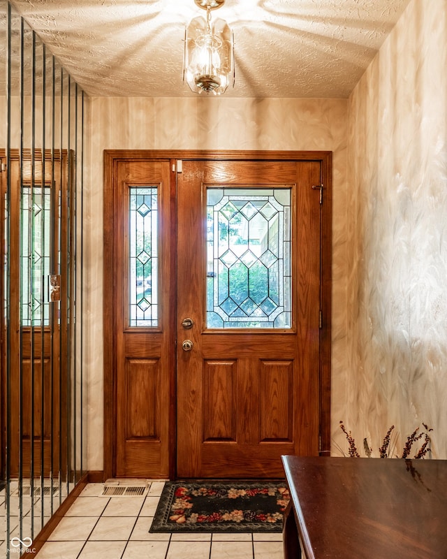 5123 Marble Ct, Indianapolis, IN 46237 - foyer entrance featuring a textured ceiling and light tile patterned floors