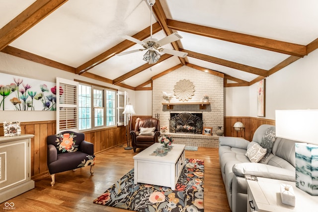 5123 Marble Ct, Indianapolis, IN 46237 - living room with wainscoting, wood finished floors, a ceiling fan, wood walls, and a fireplace