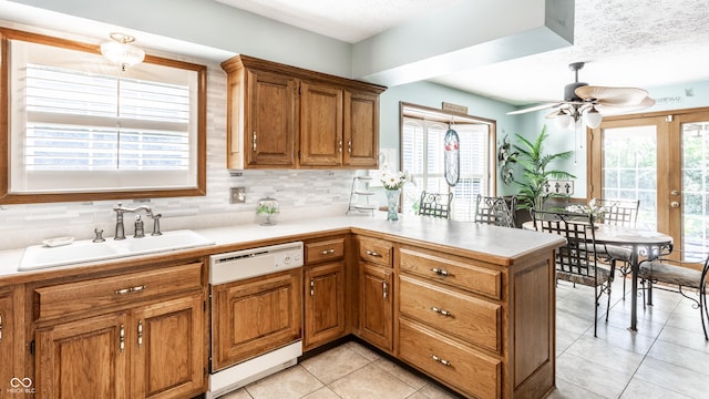 5123 Marble Ct, Indianapolis, IN 46237 - kitchen featuring white dishwasher, a ceiling fan, brown cabinets, light countertops, and a textured ceiling