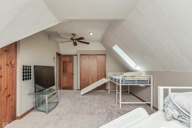 3696 Lakeshore Ct, Greenwood, IN 46143 - carpeted bedroom featuring vaulted ceiling, a skylight, and ceiling fan