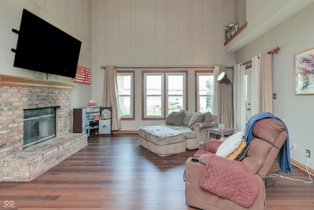 3696 Lakeshore Ct, Greenwood, IN 46143 - living room featuring a high ceiling, wood finished floors, and a brick fireplace