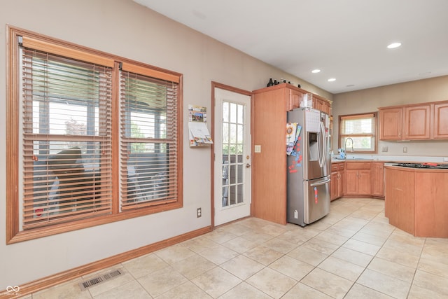 3696 Lakeshore Ct, Greenwood, IN 46143 - kitchen featuring stainless steel refrigerator with ice dispenser, light tile patterned floors, light brown cabinetry, recessed lighting, and light countertops