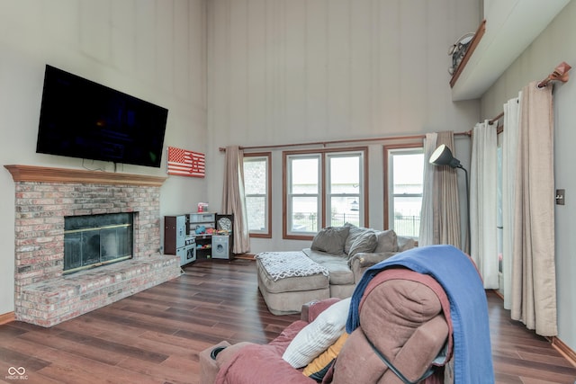 3696 Lakeshore Ct, Greenwood, IN 46143 - living room featuring wood finished floors, healthy amount of natural light, a towering ceiling, and a fireplace