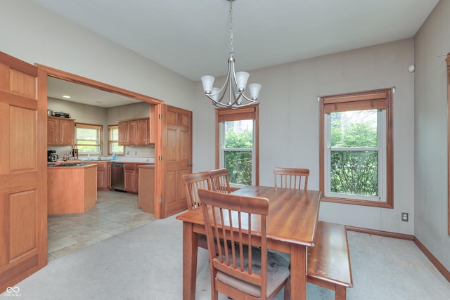 3696 Lakeshore Ct, Greenwood, IN 46143 - dining room featuring a chandelier, light colored carpet, and healthy amount of natural light