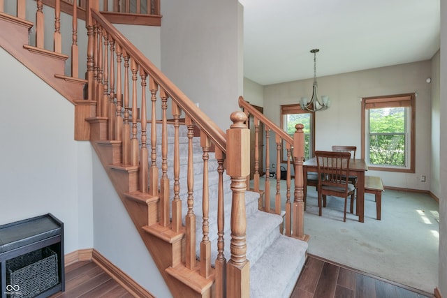 3696 Lakeshore Ct, Greenwood, IN 46143 - staircase featuring a chandelier and wood finished floors