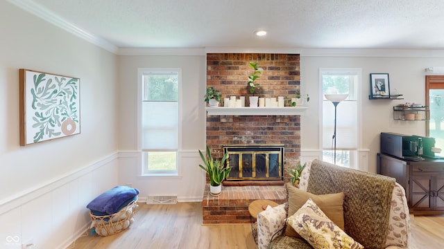 1623 Beech Cir, Plainfield, IN 46168 - living area with a wainscoted wall, wood finished floors, crown molding, a brick fireplace, and a decorative wall
