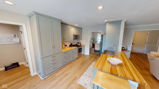 1623 Beech Cir, Plainfield, IN 46168 - kitchen with appliances with stainless steel finishes, gray cabinets, wooden counters, light wood-style flooring, and ornamental molding