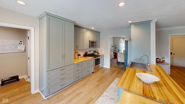 1623 Beech Cir, Plainfield, IN 46168 - kitchen featuring appliances with stainless steel finishes, gray cabinetry, wooden counters, light wood-type flooring, and recessed lighting