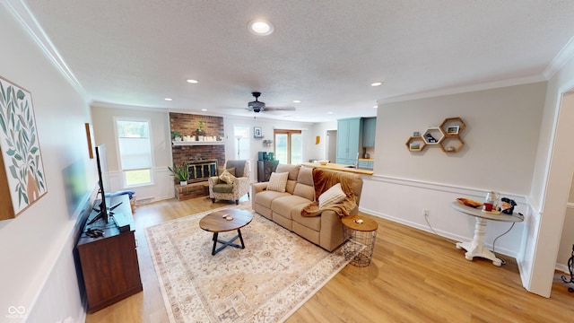 1623 Beech Cir, Plainfield, IN 46168 - living room with healthy amount of natural light, light wood-style flooring, a fireplace, ornamental molding, and recessed lighting