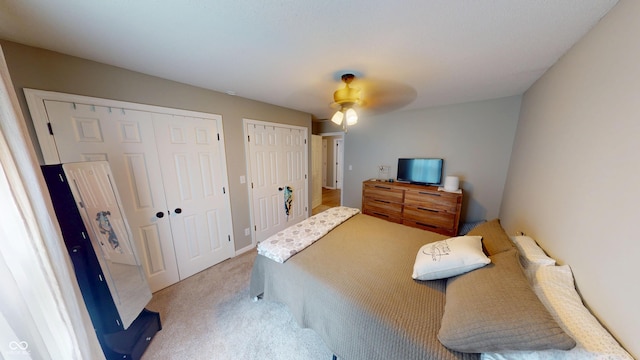 1623 Beech Cir, Plainfield, IN 46168 - bedroom with two closets, light colored carpet, and a ceiling fan