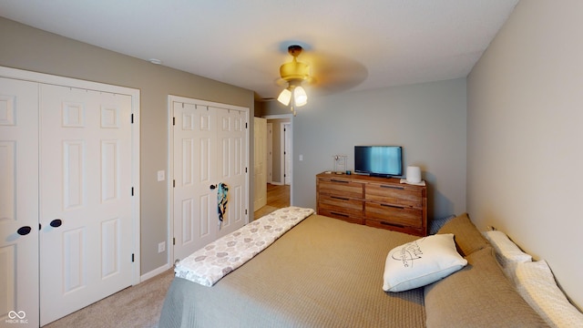 1623 Beech Cir, Plainfield, IN 46168 - bedroom featuring light colored carpet, multiple closets, and ceiling fan