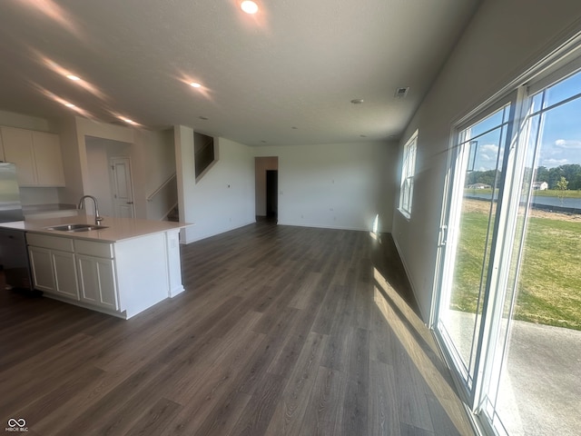 7893 Magnolia St, New Palestine, IN 46163 - kitchen with white cabinetry, dark wood finished floors, light countertops, open floor plan, and an island with sink