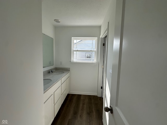 7893 Magnolia St, New Palestine, IN 46163 - bathroom with double vanity, wood finished floors, and a textured ceiling
