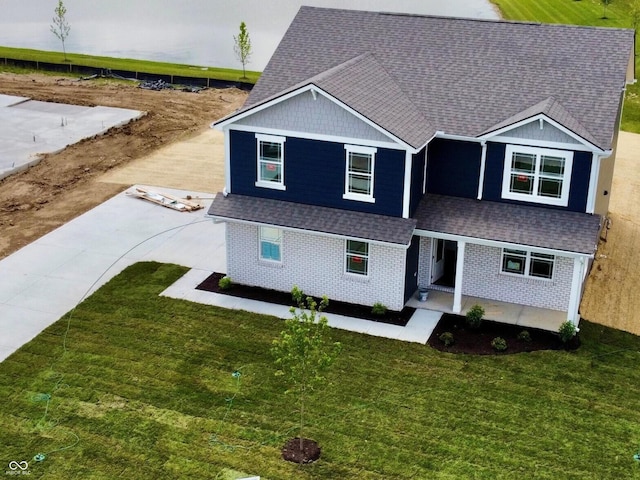 7893 Magnolia St, New Palestine, IN 46163 - view of front of property featuring a shingled roof, a front yard, and brick siding