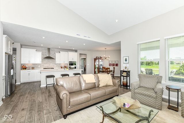1360 Petit Verdot Dr, Westfield, IN 46074 - living room with plenty of natural light, wood finished floors, a chandelier, vaulted ceiling, and recessed lighting