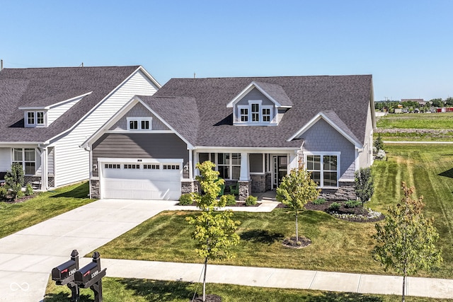 1360 Petit Verdot Dr, Westfield, IN 46074 - view of front of property featuring stone siding, roof with shingles, driveway, and a front lawn