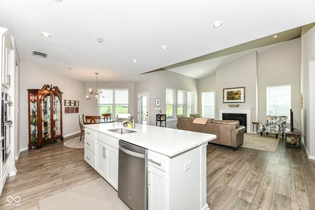 1360 Petit Verdot Dr, Westfield, IN 46074 - kitchen with vaulted ceiling, stainless steel dishwasher, light wood-type flooring, an island with sink, and light countertops