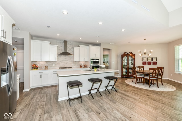 1360 Petit Verdot Dr, Westfield, IN 46074 - kitchen featuring appliances with stainless steel finishes, light wood-type flooring, decorative backsplash, white cabinets, and recessed lighting
