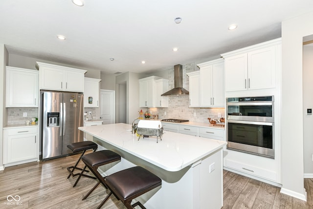 1360 Petit Verdot Dr, Westfield, IN 46074 - kitchen with stainless steel appliances, backsplash, white cabinetry, light wood-style flooring, and recessed lighting