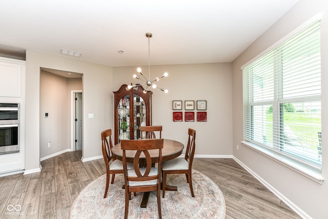 1360 Petit Verdot Dr, Westfield, IN 46074 - dining area featuring healthy amount of natural light, a chandelier, and light wood finished floors