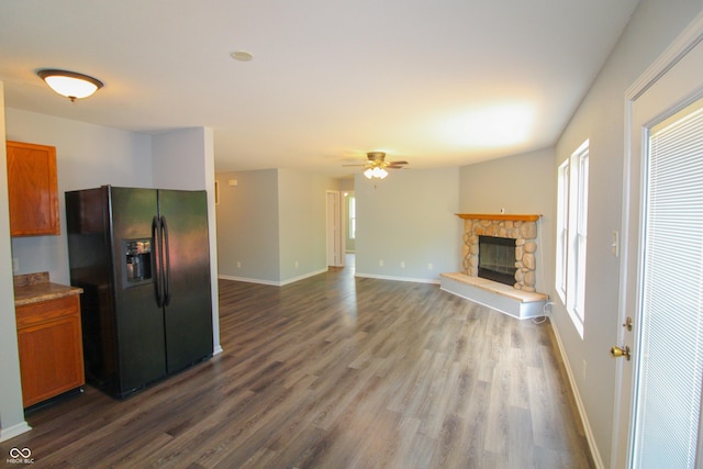10610 Pavilion Dr, Indianapolis, IN 46259 - kitchen featuring black fridge, healthy amount of natural light, dark wood-style flooring, and brown cabinets