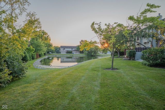 7151 Sea Pine Dr, Indianapolis, IN 46250 - yard at dusk featuring a yard and a water view