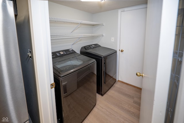7151 Sea Pine Dr, Indianapolis, IN 46250 - laundry room featuring independent washer and dryer and light wood-style flooring