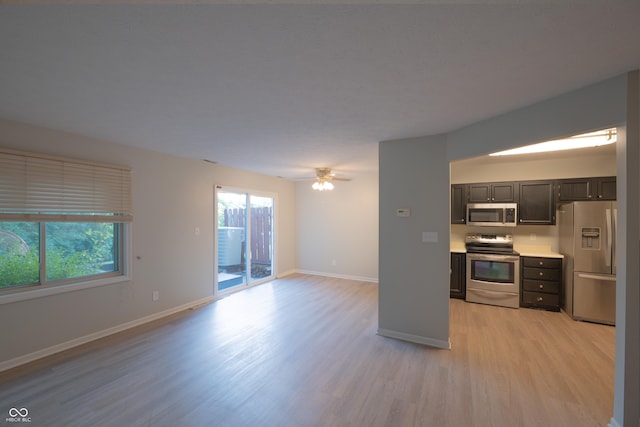 7151 Sea Pine Dr, Indianapolis, IN 46250 - kitchen featuring stainless steel appliances, light wood-type flooring, open floor plan, light countertops, and ceiling fan