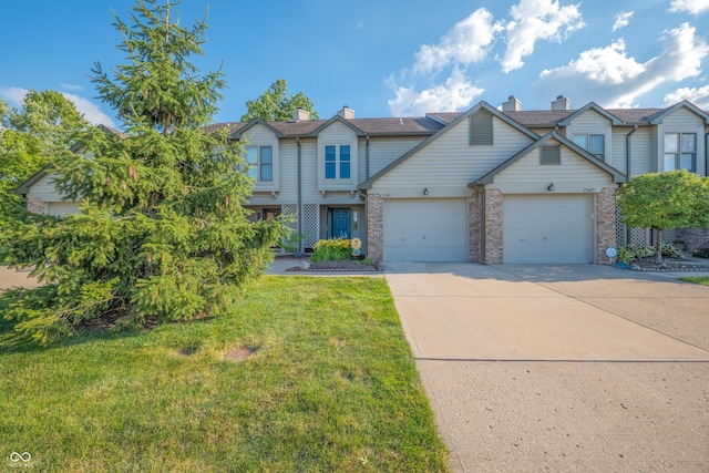 7151 Sea Pine Dr, Indianapolis, IN 46250 - view of front of property featuring driveway, a front lawn, brick siding, and an attached garage