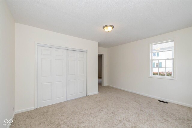 149 E Jackson St, Cicero, IN 46034 - unfurnished bedroom with carpet flooring and a closet