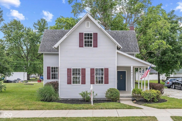 149 E Jackson St, Cicero, IN 46034 - traditional-style home with covered porch, a front yard, roof with shingles, and a chimney