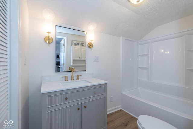 149 E Jackson St, Cicero, IN 46034 - full bathroom featuring wood finished floors, vanity, a textured ceiling, shower / bath combination, and vaulted ceiling