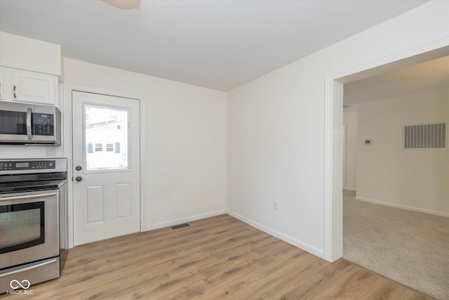 149 E Jackson St, Cicero, IN 46034 - kitchen with stainless steel appliances, light wood-type flooring, and white cabinetry