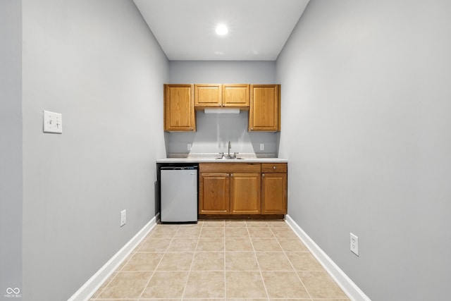 13004 Tuscany Blvd, Carmel, IN 46032 - kitchen featuring light countertops, dishwasher, and brown cabinets