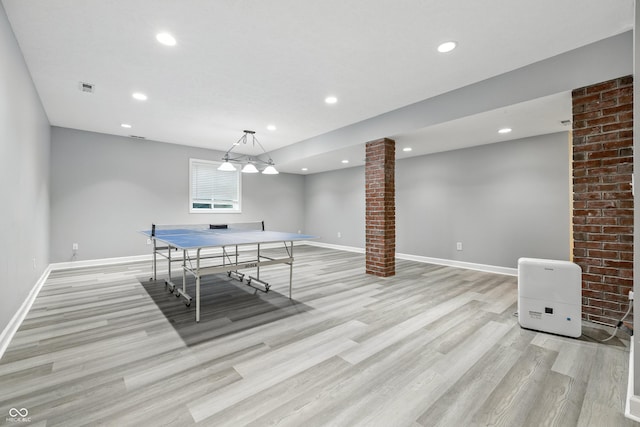 13004 Tuscany Blvd, Carmel, IN 46032 - recreation room with ornate columns, light wood finished floors, and recessed lighting