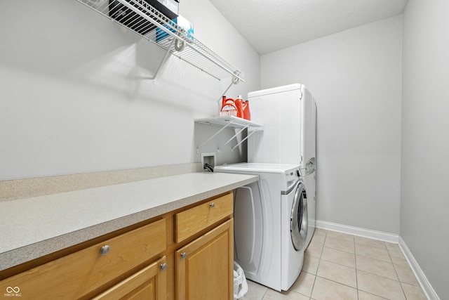 13004 Tuscany Blvd, Carmel, IN 46032 - laundry area featuring washer / clothes dryer, light tile patterned flooring, and cabinet space