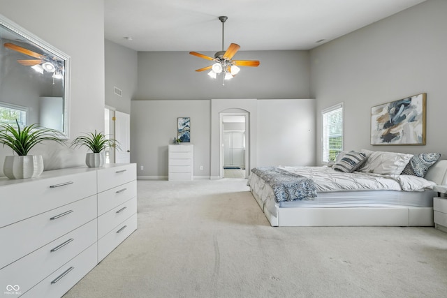 13004 Tuscany Blvd, Carmel, IN 46032 - bedroom featuring high vaulted ceiling, light colored carpet, arched walkways, multiple windows, and ceiling fan